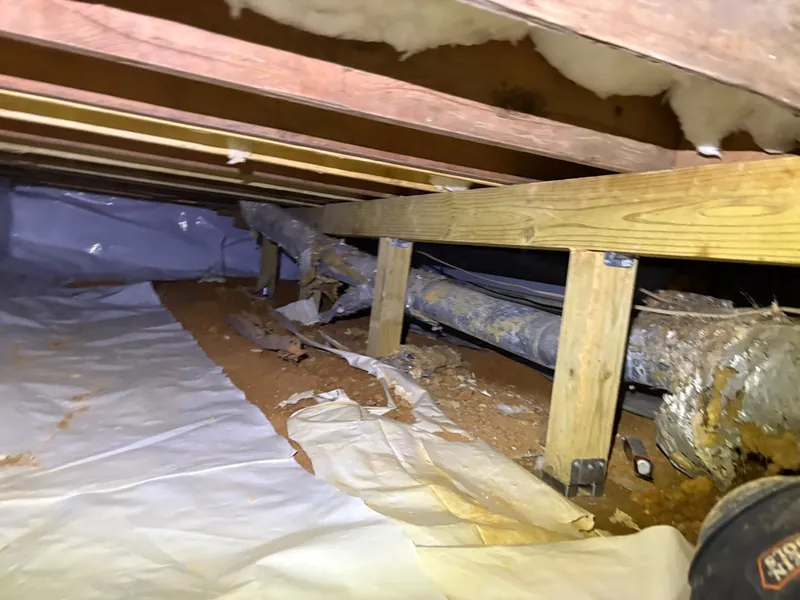 Corroded pipes and aging structure under a home