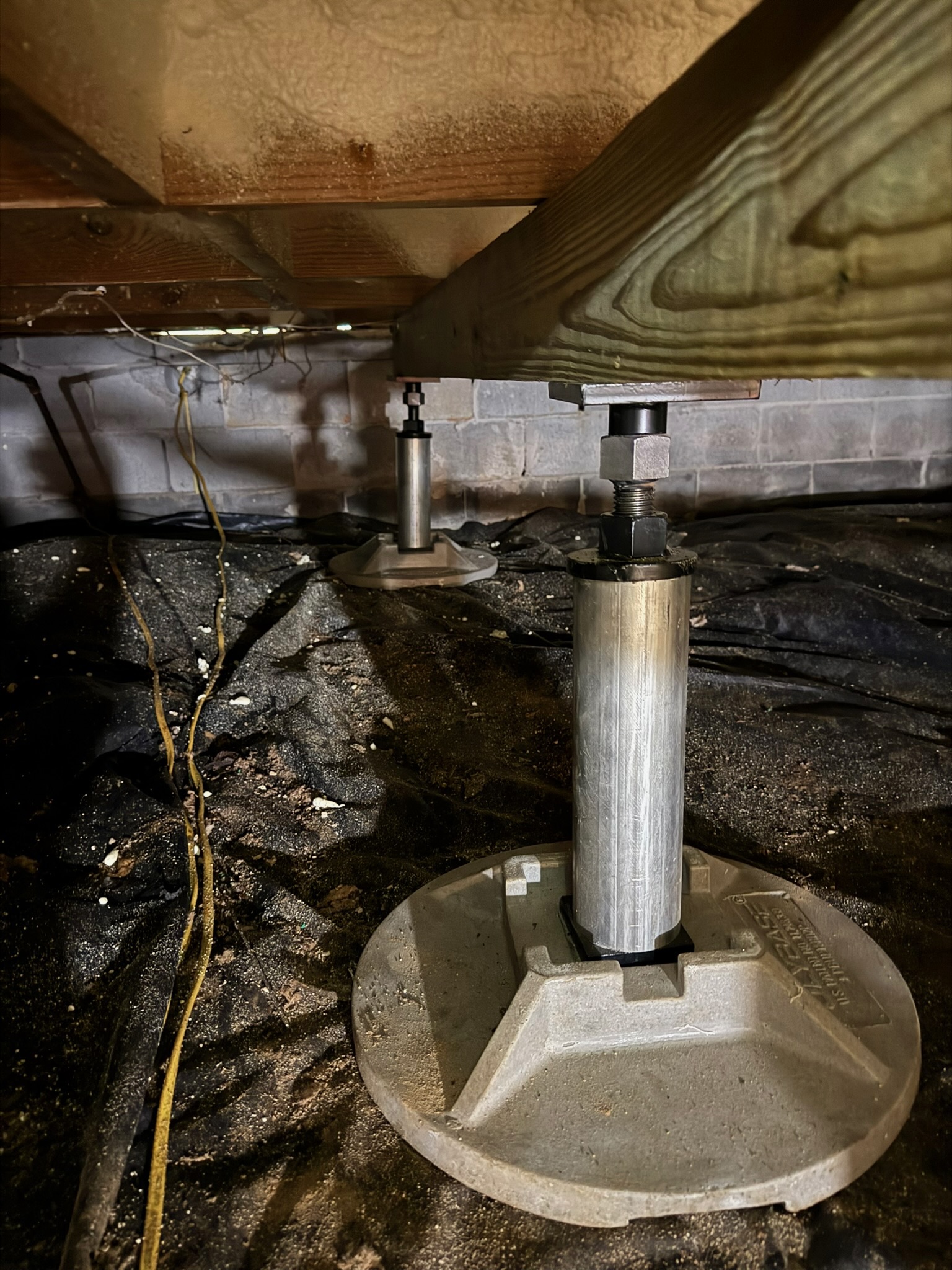 Structural support work beneath a home